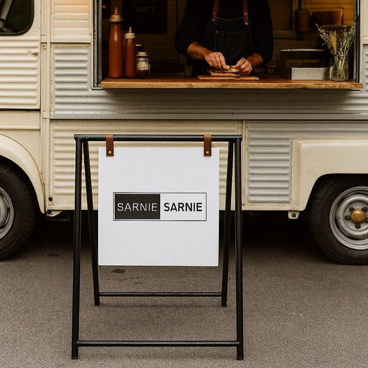 Food truck with a person preparing sandwiches, branded 'Sarnie Sarnie'.