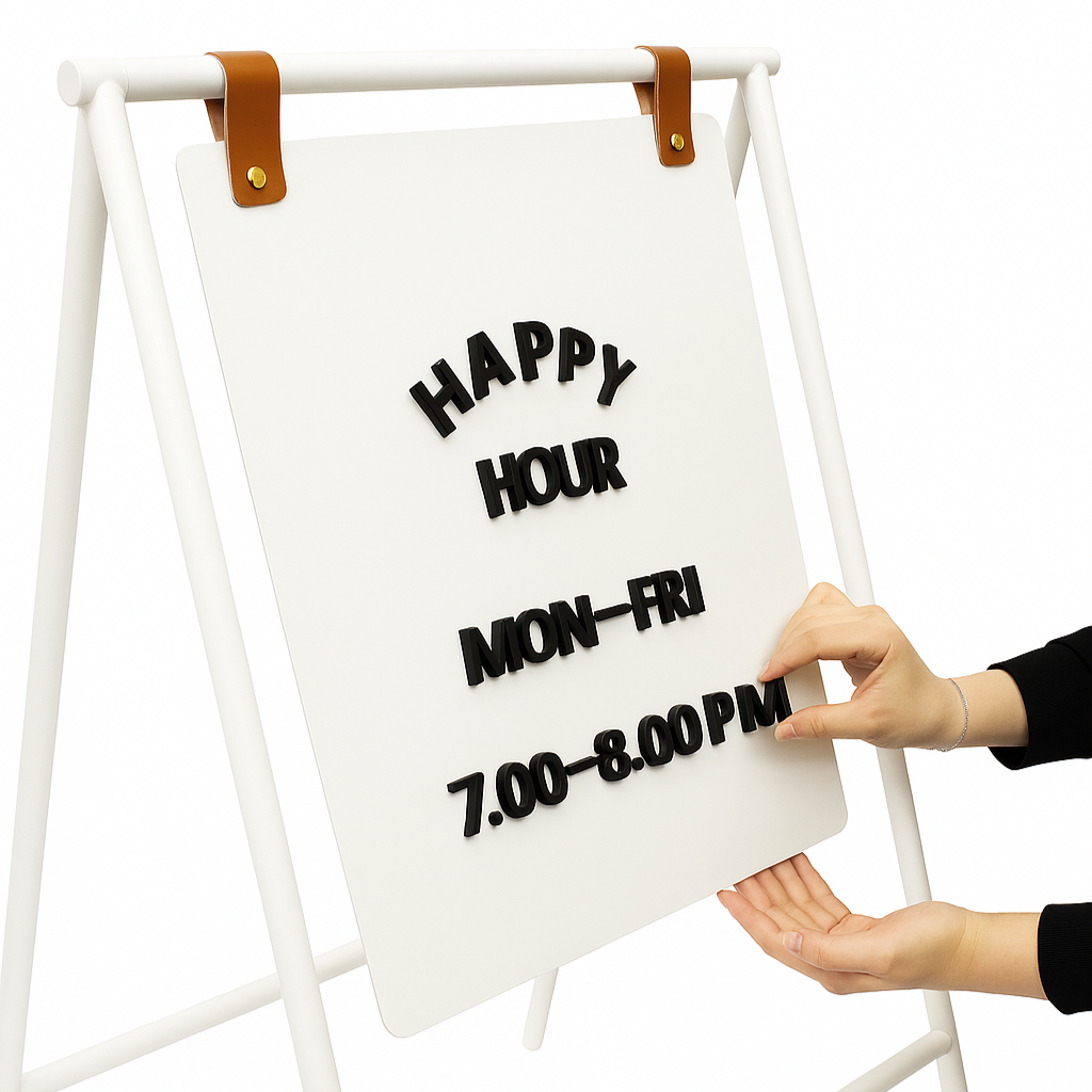 Person adjusting a white sign with 'Happy Hour' text on a stand against a white background