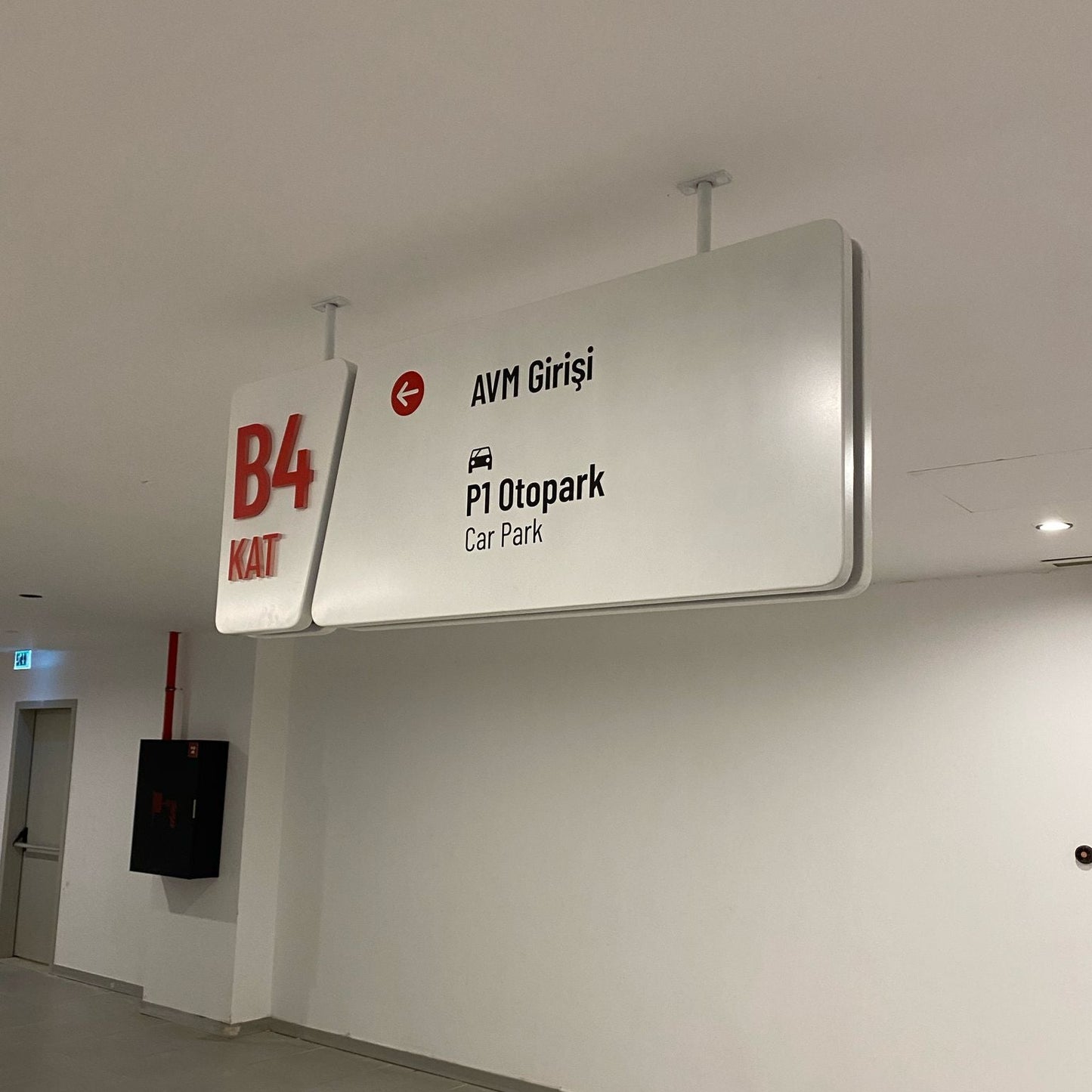 Signage indicating floor levels and parking information in a building interior.