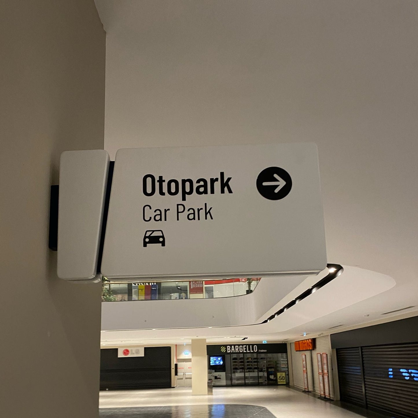 Sign pointing to Otpark Car Park in a building interior