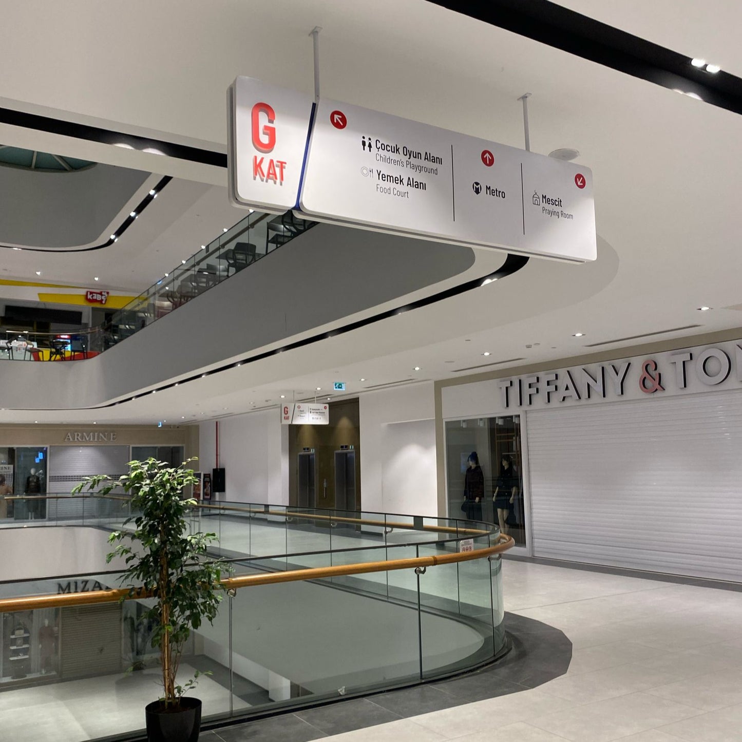 Mall interior with Tiffany & Co. store and directional signs.
