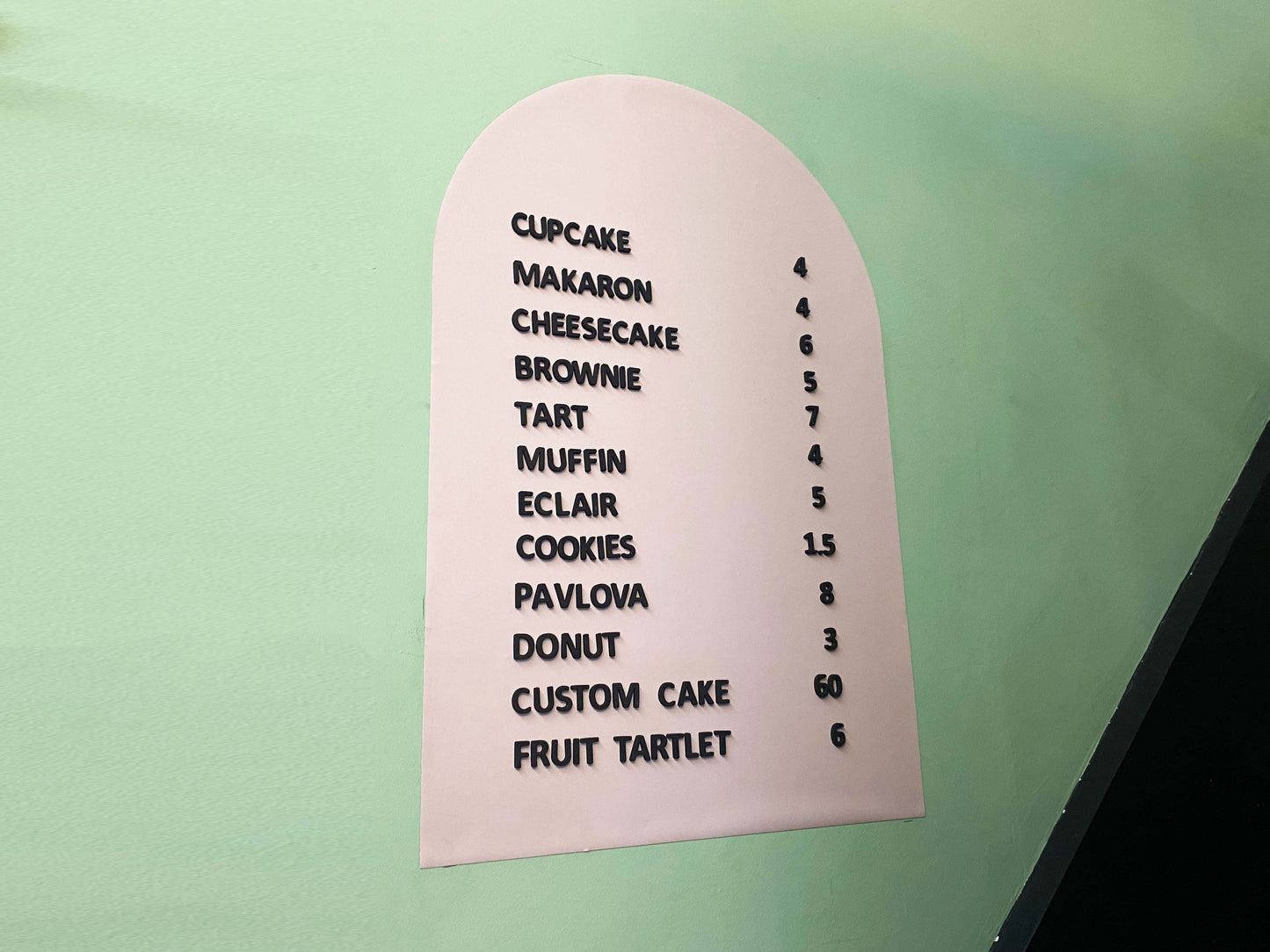 A sleek and modern magnetic letter menu board designed for cafés and coffee shops. The board features a high-quality metal surface that securely holds changeable white magnetic letters, making it easy to update menus, prices, or special offers. Its minimalist black design complements various interiors, from rustic coffee houses to contemporary cafés. Ideal for daily updates, seasonal promotions, and highlighting featured drinks, this magnetic menu board adds both style and functionality to any business.