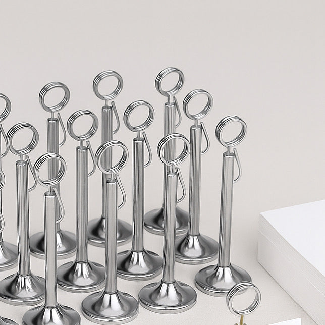 Set of metallic photo holders on a white surface