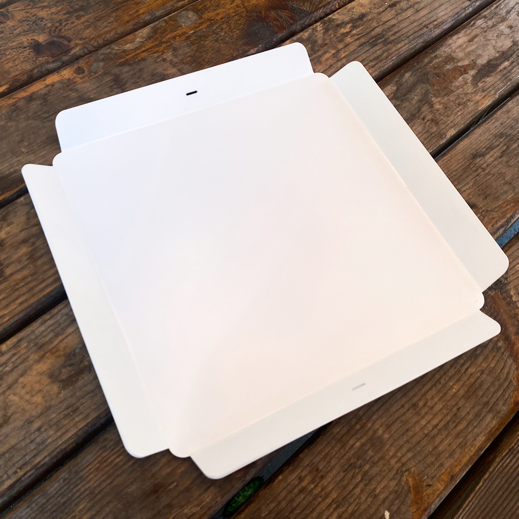 White square filters stacked on a wooden surface