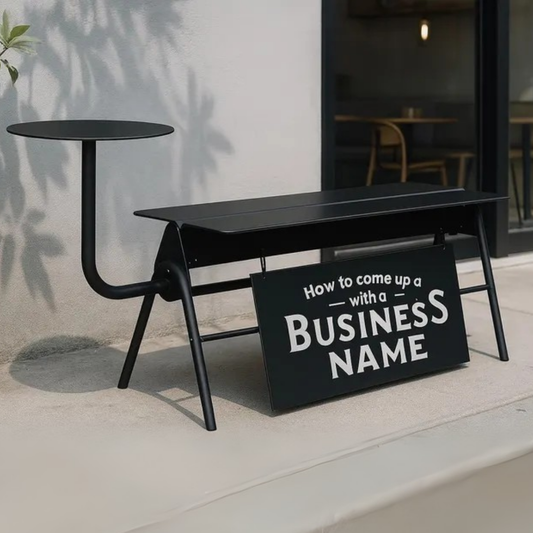Black metal bench with a sign reading 'How to come up with a business name' in an outdoor setting.