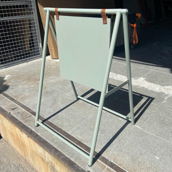Outdoor double-sided sidewalk sign showcasing custom artwork, ideal for drawing attention to your business in high-traffic areas.





