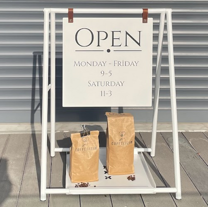 Double-sided A-frame sidewalk sign with a tray for small businesses, offering a practical solution for displaying promotions or menus. The tray beneath the sign adds extra space for promotional items, making it a versatile tool. Also known as a ‘small business sign’ or ‘cafe sign,’ this sign is durable and attention-grabbing.

