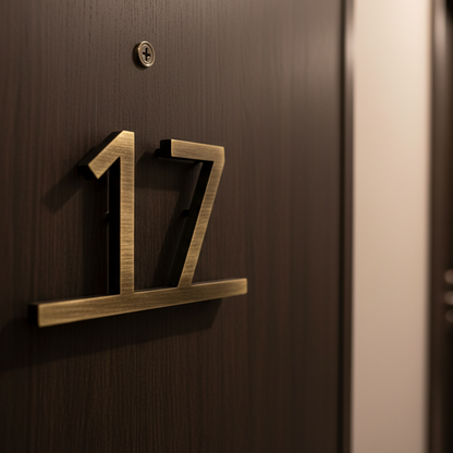 Brass house number '17' on a wooden door