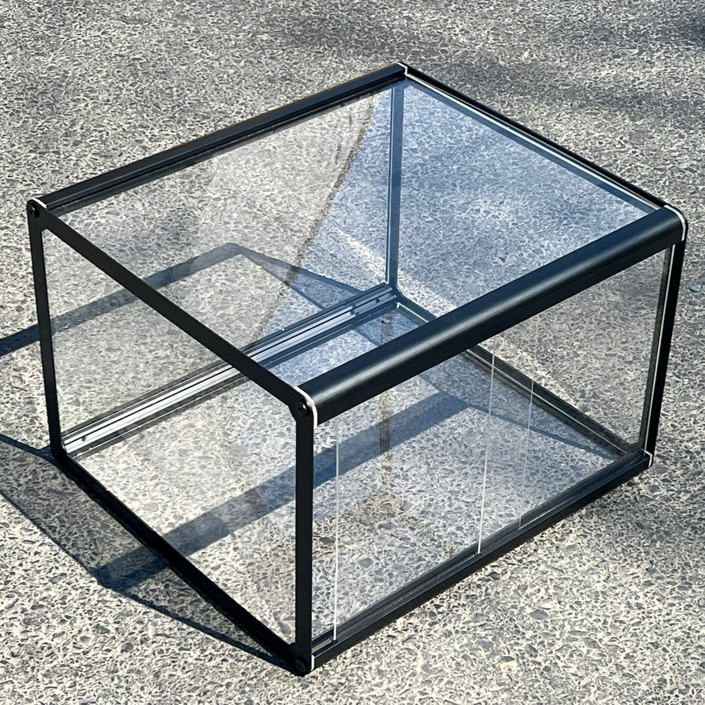 Glass display case on a concrete surface