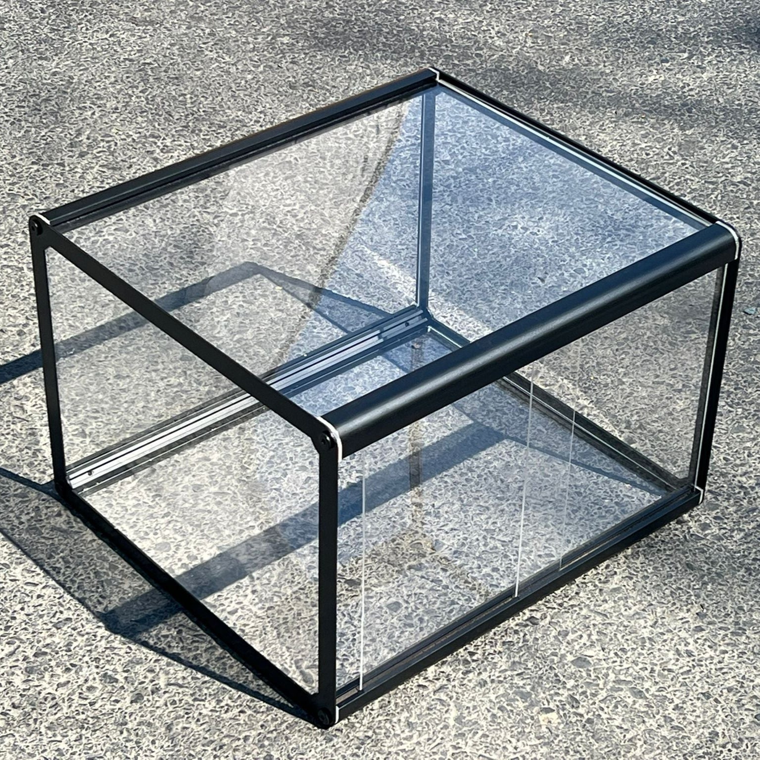 Glass display case on a concrete surface