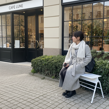 Person sitting on a bench outside a cafe named 'Café Lune'.