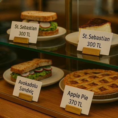 Display case with various pastries and sandwiches labeled with prices.