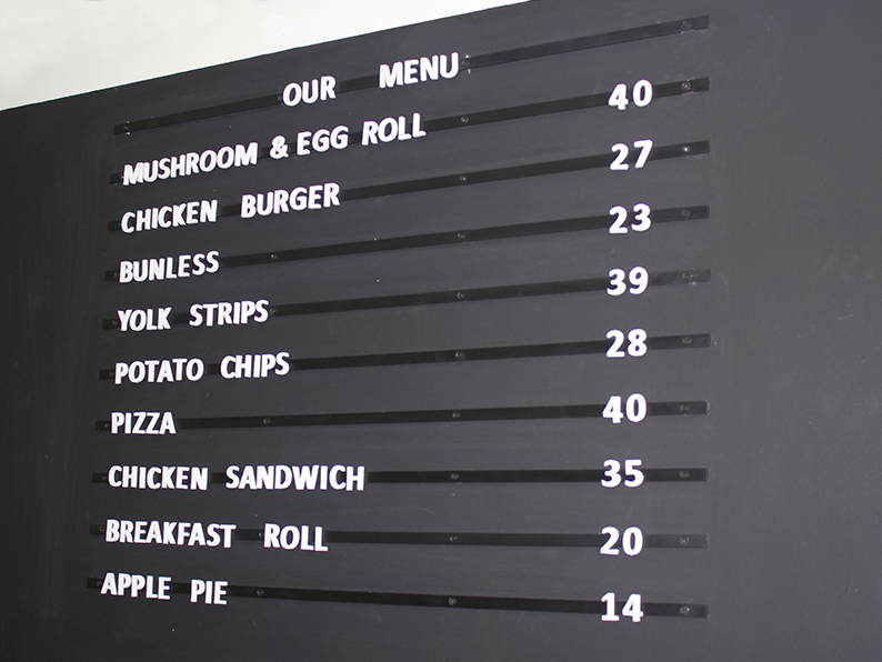 Magnetic letter menu board displayed in a coffee shop.