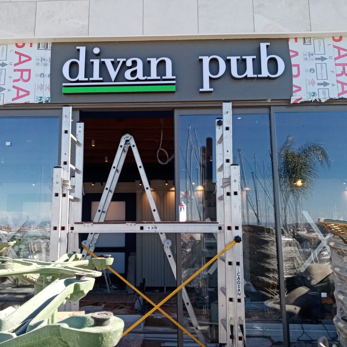 Divan Pub storefront with construction scaffolding in front