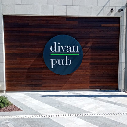 Wooden garage door with 'divan pub' logo on a building exterior.