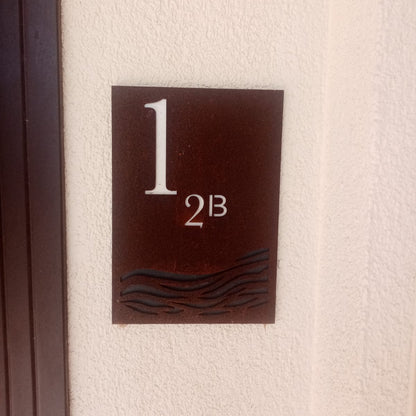 House number sign '12B' on a textured wall