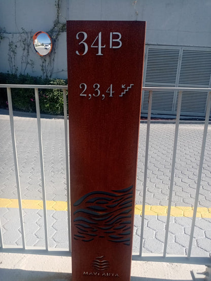 Tall red sign with '34B' and '2,3,4' on a white wall background