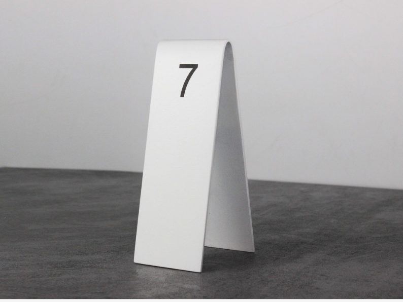 "Personalized double-sided table numbers, perfect for cafes and restaurants. Customization options include QR codes, logos, and reserved signs."

