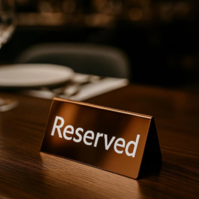 Reserved sign on a table in a restaurant with blurred background