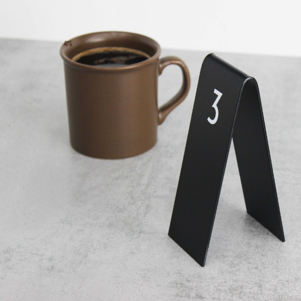 Double-sided Custom Table Number Stackers designed for weddings, cafes, and restaurants. Available with QR code printing and customizable in metal or wood to match any business aesthetic.