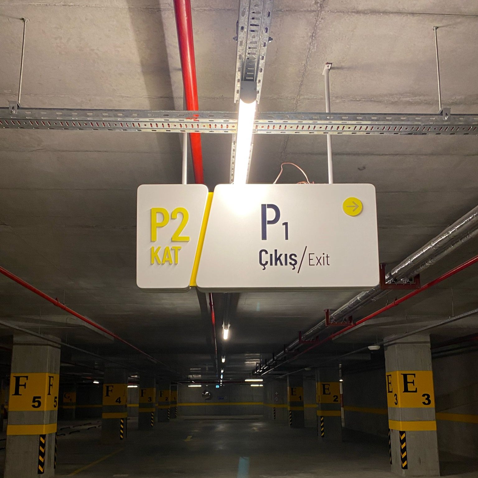 Underground parking garage with a sign indicating P2 KAT and EXIT.