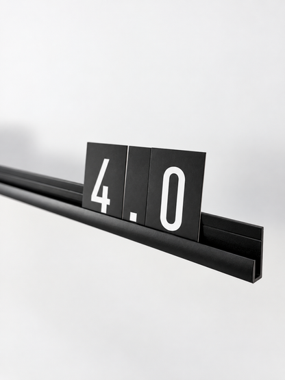 Close-up of black aluminum letter board rail profile with interchangeable number cards