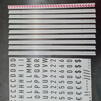 Set of metal strips with printed characters on a dark surface