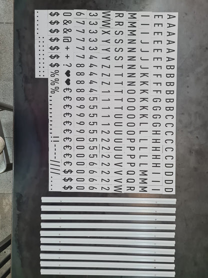 Set of metal letters and symbols on a metallic surface