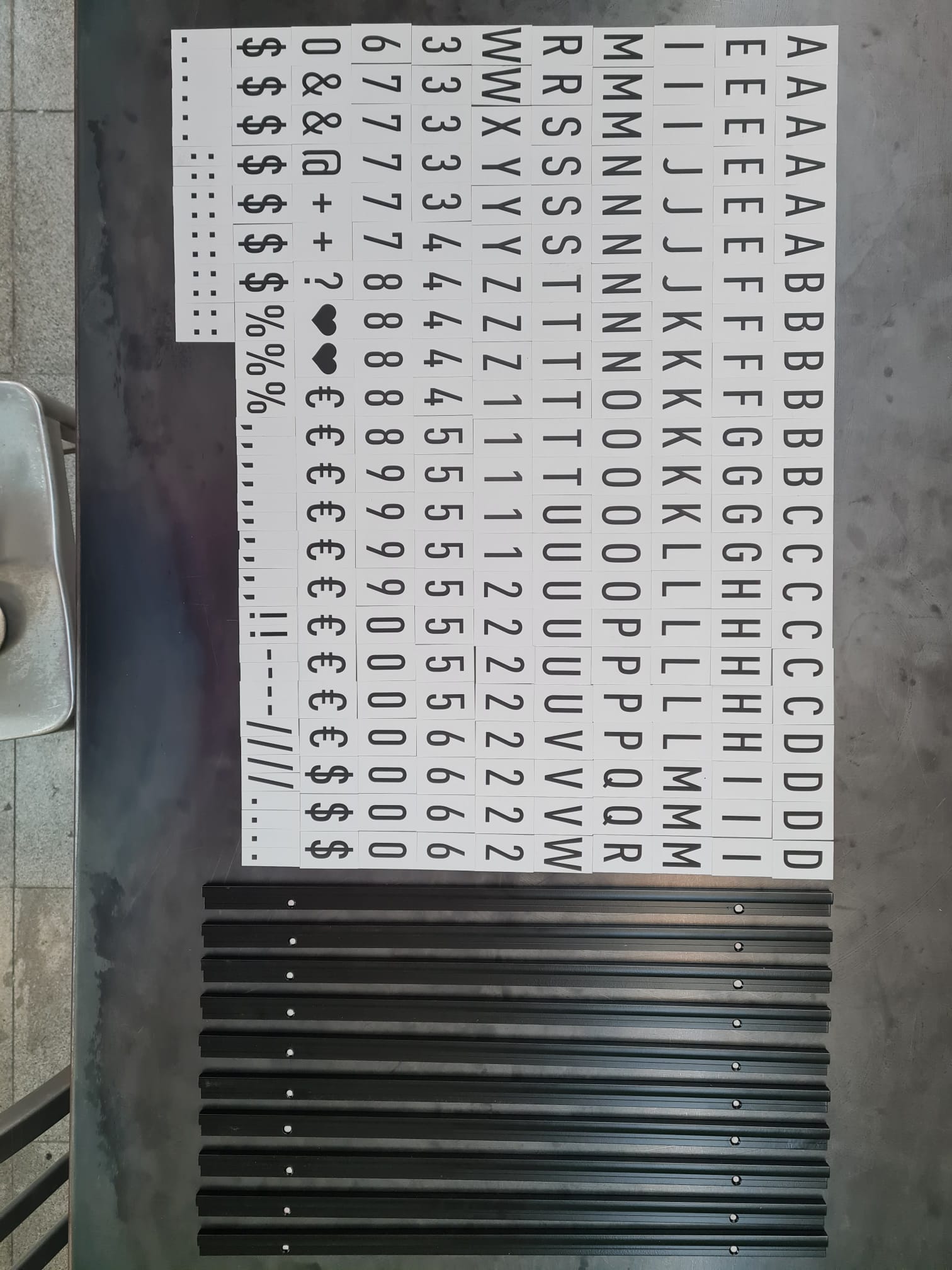 Sheet of typewriter keys and characters on a metallic surface