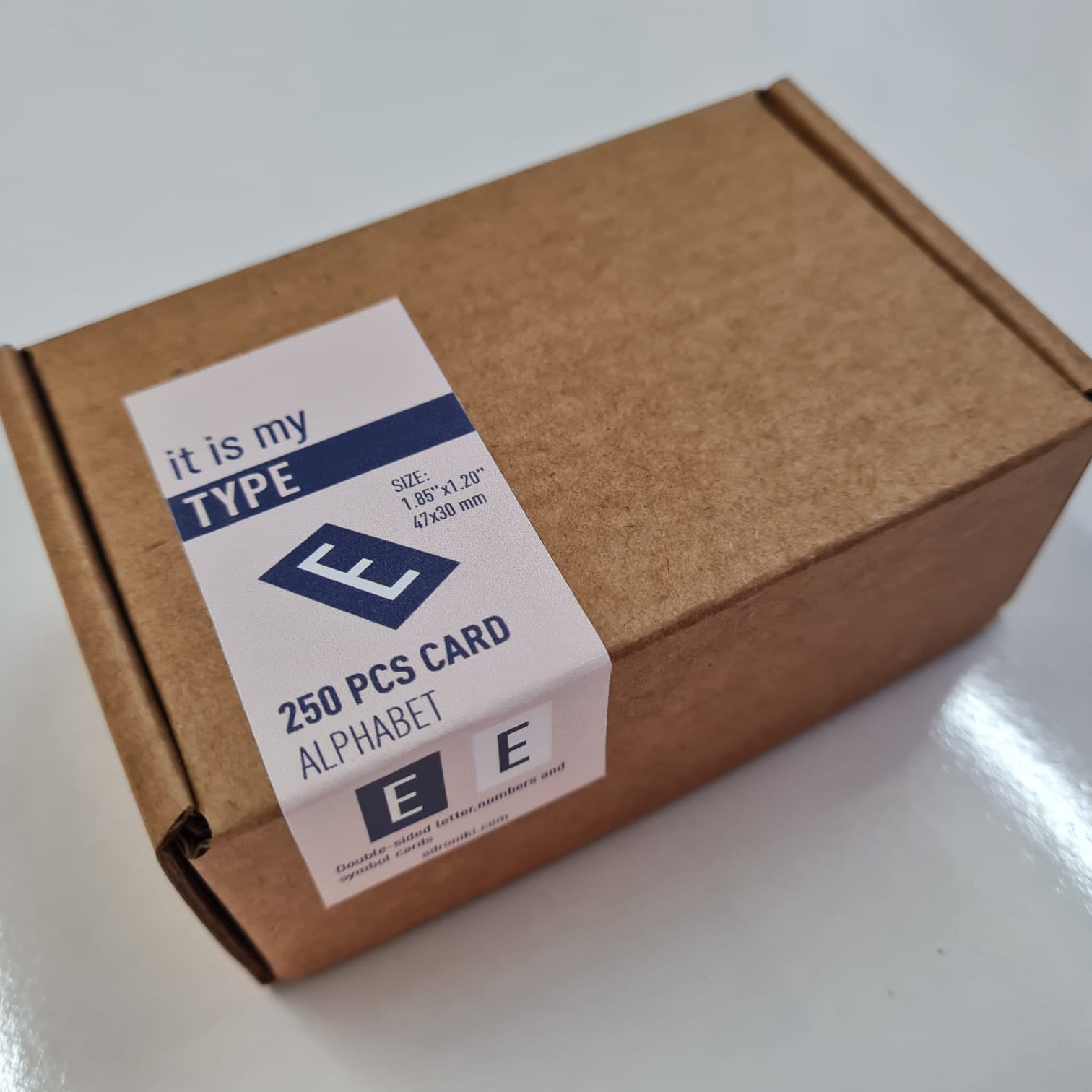 Brown cardboard box with a label on a white surface