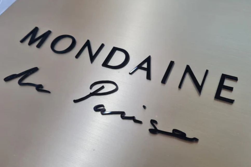 Mondaine logo on a metallic surface