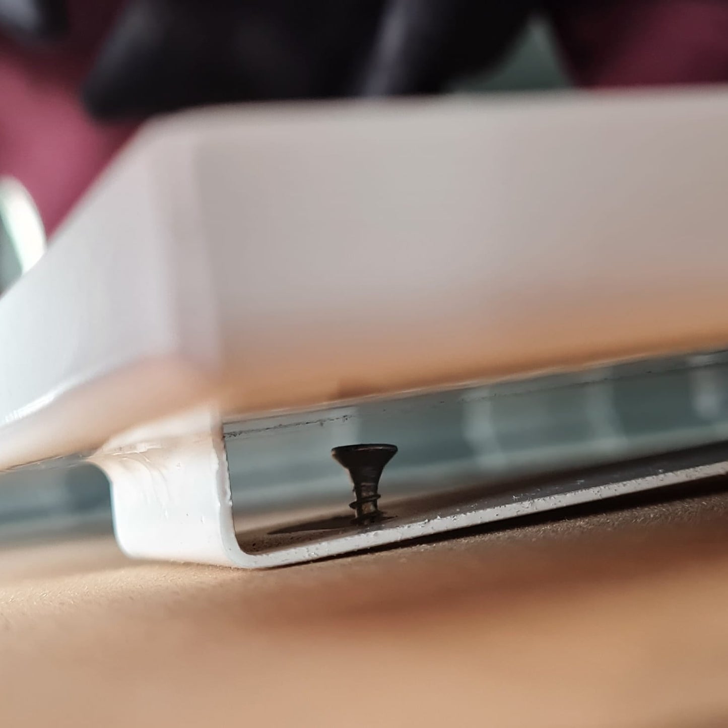 Close-up of a smartphone with a cut screen, held by a person.