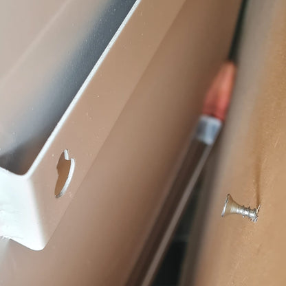 Close-up of a screw on a wooden surface with a blurred background
