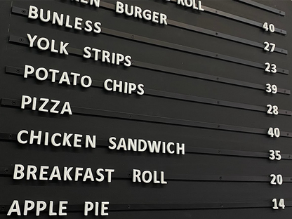 Magnetic menu board with repositionable foam letters for café menu updates.
