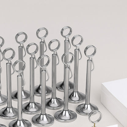 Set of metallic photo holders on a white surface