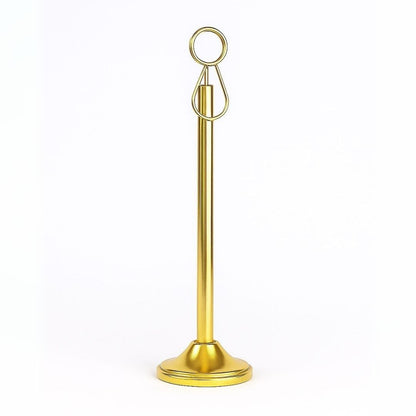 Gold metal stand with circular top on a white background