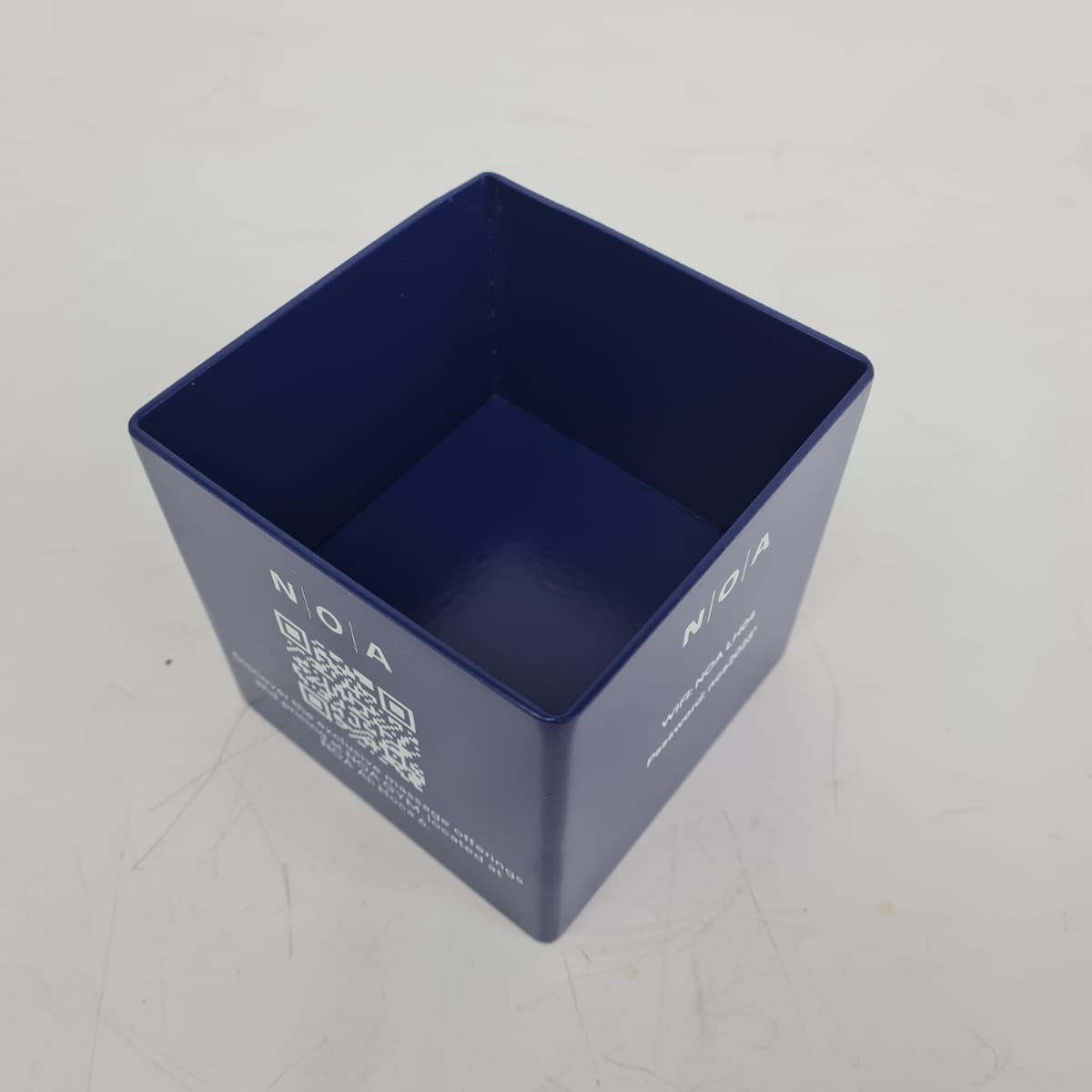 Blue square container with a QR code on a light gray background