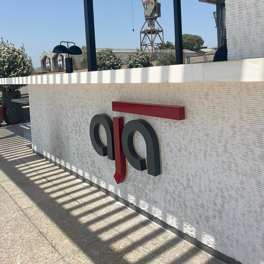 Logo of Aja on a building exterior with clear sky