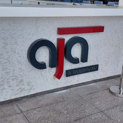 Logo of AIA on a building facade with glass windows in the background
