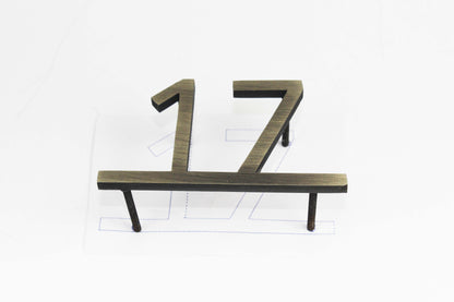 This modern door number sign features clean lines and a simple yet striking metallic finish. Its minimalist design seamlessly integrates into different architectural styles, from contemporary offices to high-end apartments. The reflective surface catches light beautifully, enhancing visibility while maintaining an understated elegance. A must-have for those who appreciate modern aesthetics and practicality.

