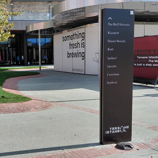 Outdoor area with a signpost and building in the background