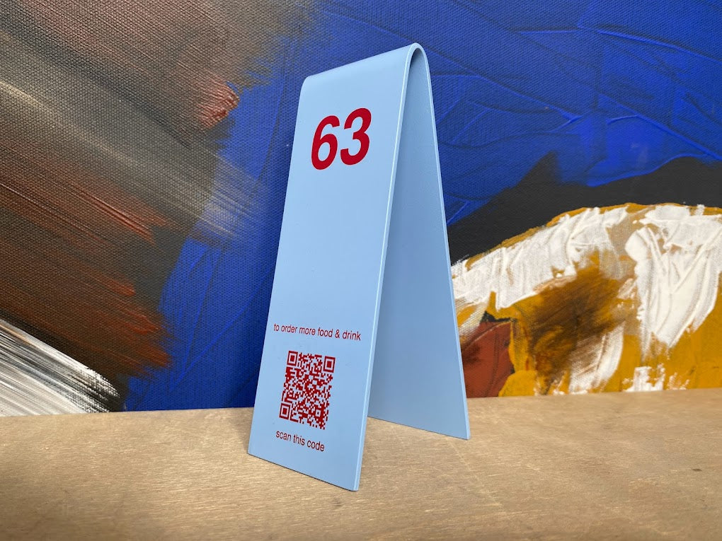 "Double-sided Custom Table Number Stackers designed for weddings, cafes, and restaurants. Available with QR code printing and customizable in metal or wood to match any business aesthetic."

