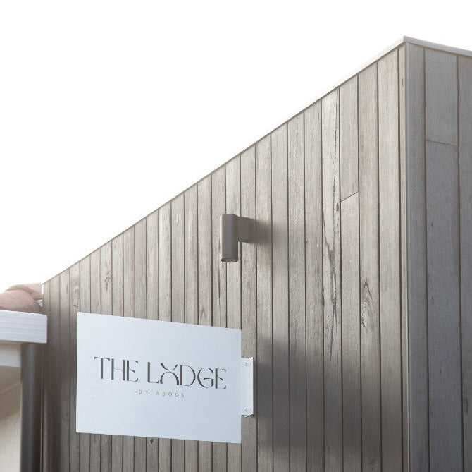 Wooden building exterior with 'The Lydige' sign