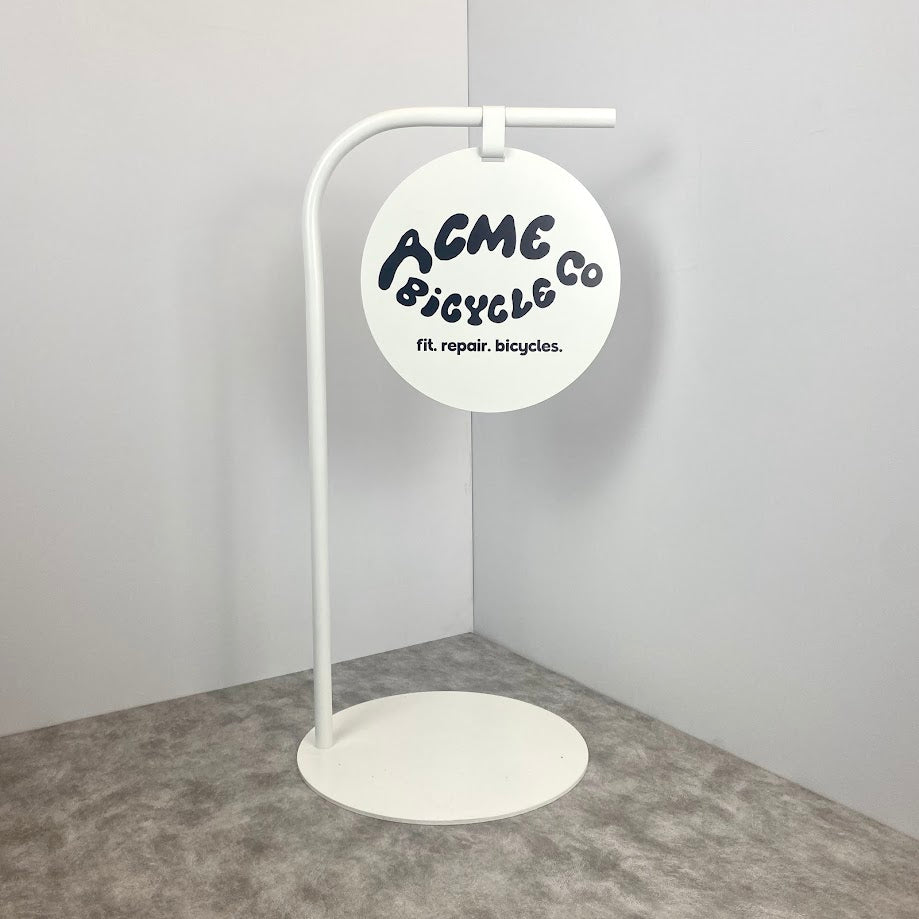 Make your business stand out with this modern round sign on a sturdy metal base.