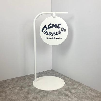 Make your business stand out with this modern round sign on a sturdy metal base.