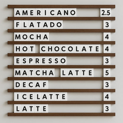 Letterboard with coffee drink options and prices on a white wall