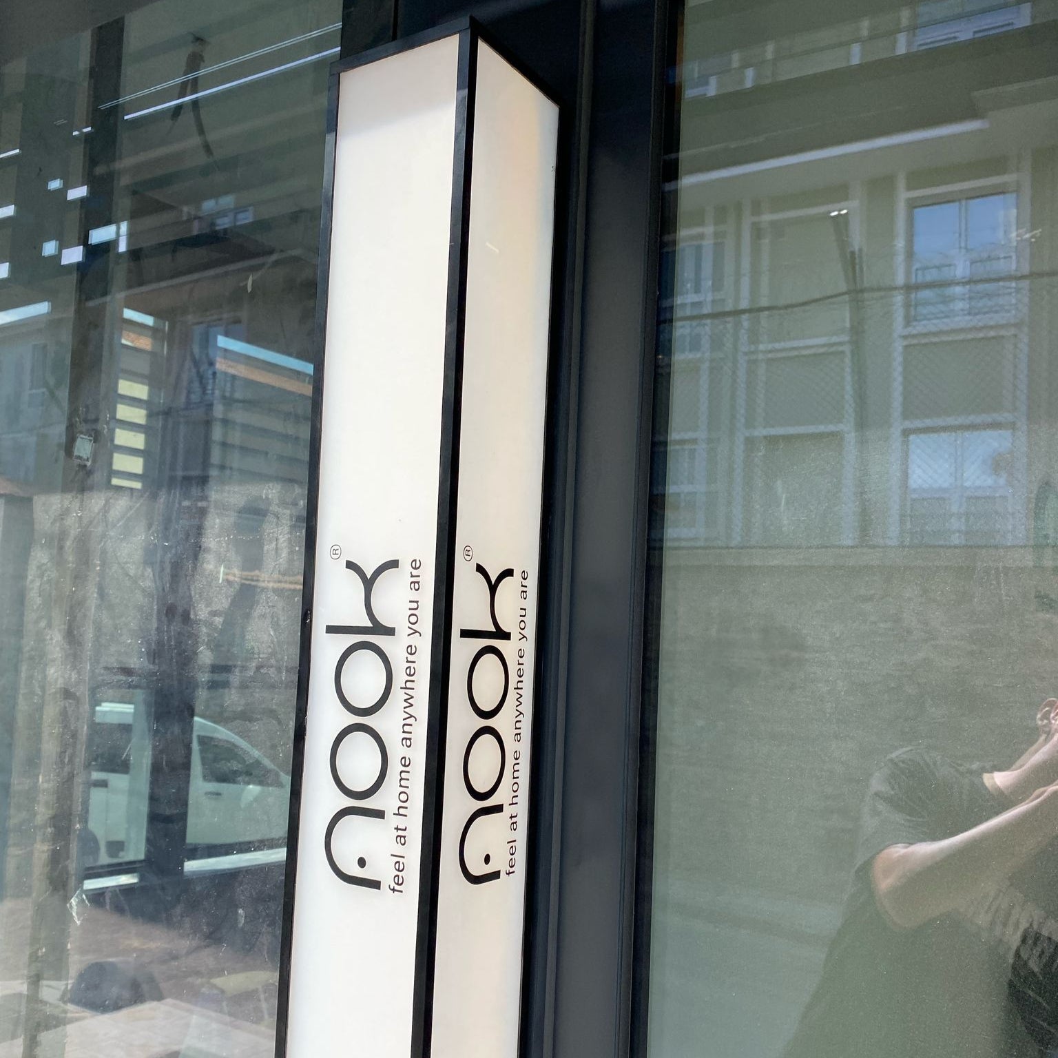 Book-shaped product with 'nook' branding on a reflective surface