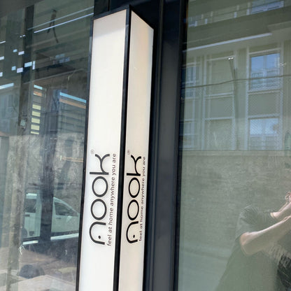 Book-shaped product with 'nook' branding on a reflective surface