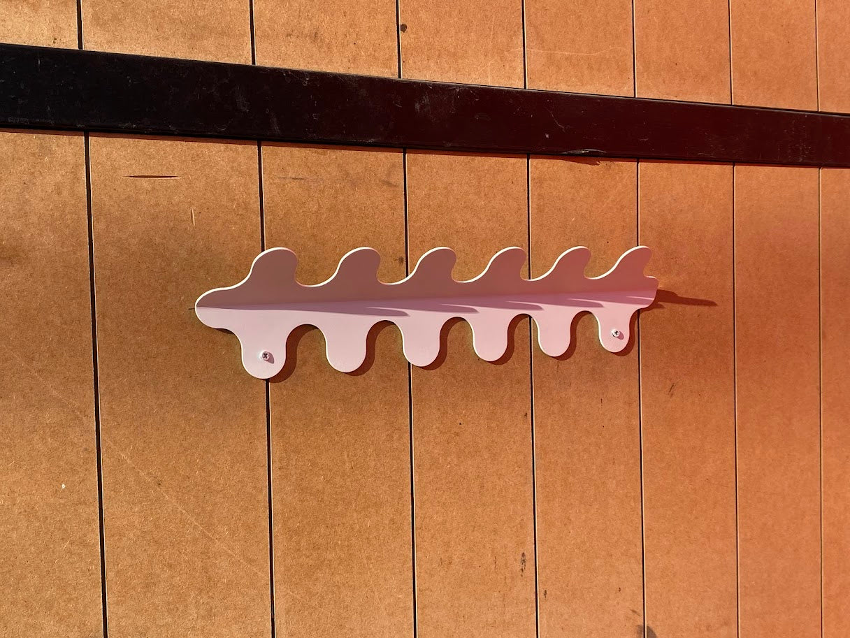 The wall-mounted curved hanger adds a distinct touch to your room with its wavy design. Made from durable metal, this hanger offers a secure place to hang your jackets, bags, and accessories while adding an aesthetic element to your walls. Perfect for busy areas, it helps keep your space organized and stylish, combining form and function seamlessly.







