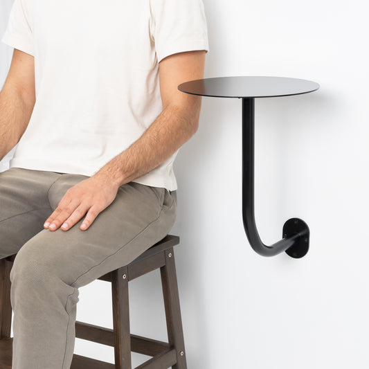 Wall mounted round table ideal for modern café interiors.